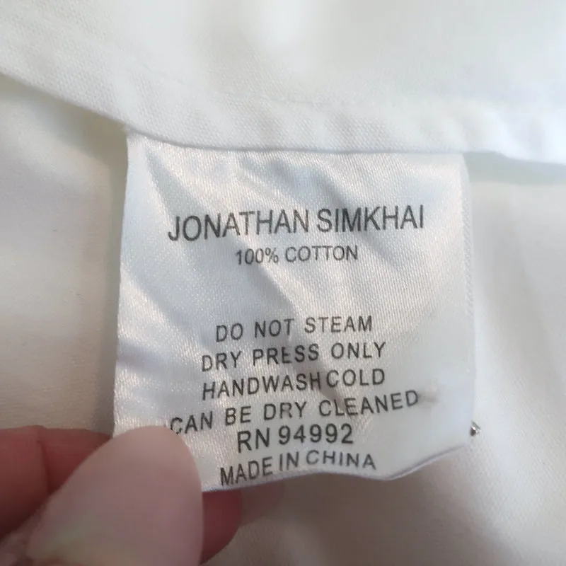 Jonathan Simkhai Haut à volants orné de fausses perles en coton blanc Taille S